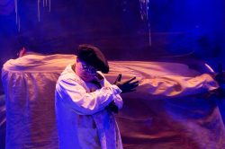 Nat Kennedy in DORIAN, based on The Picture of Dorian Gray by Oscar Wilde, written by Phoebe Eclair-Powell & Owen Horsley. Set and costume design: E.M. Parry. Dir. by Owen Horsley. Reading Rep, 2021. Photo by Holly Revell.